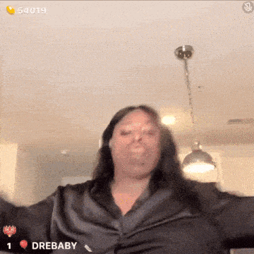 a woman wearing a black shirt with the word drebaby on the bottom right