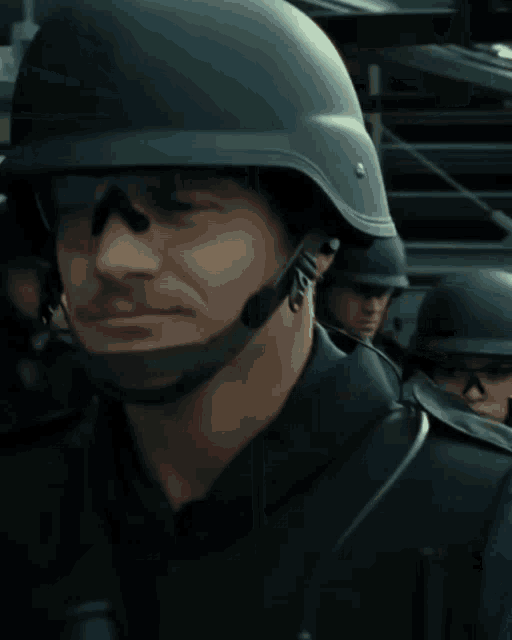 a close up of a man wearing a helmet and sunglasses