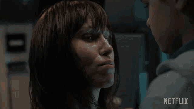 a man and a woman are looking into each other 's eyes with a netflix logo in the corner
