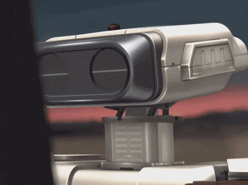 a close up of a futuristic device with the letter m on the side