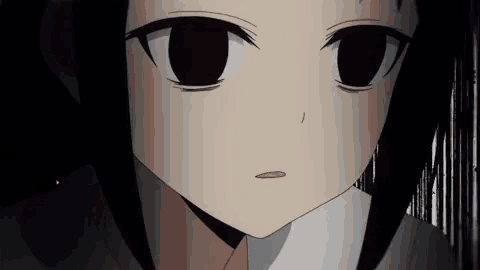 a close up of a girl 's face with black eyes and a white shirt .