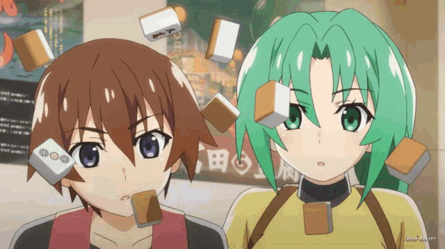 a boy and a girl are standing next to each other with blocks on their faces