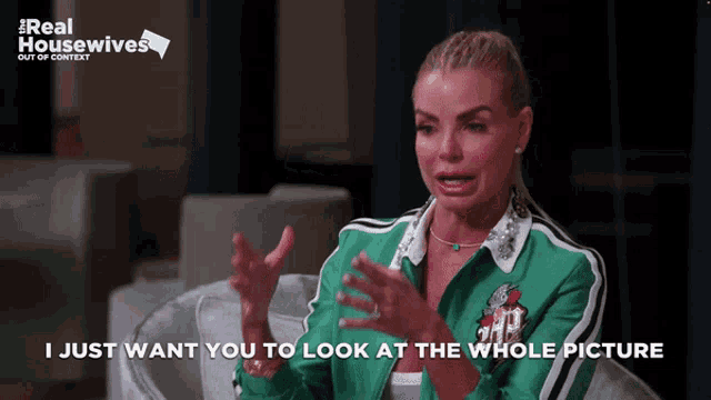 a woman in a green jacket says " i just want you to look at the whole picture " while sitting in a chair