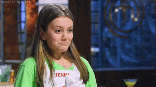 a young girl wearing a green shirt and an apron with jenn written on it