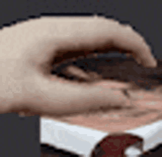 a close up of a person 's face with a hand covering it .