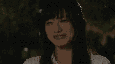 a close up of a woman 's face with a smile on her face .