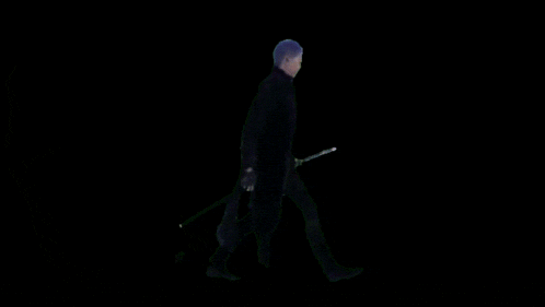 a man is walking with a sword in his hand