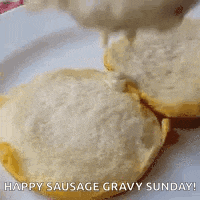 sausage gravy is being poured on a biscuit on a plate