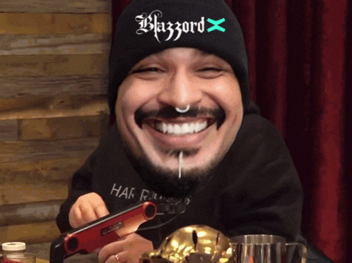 a man wearing a black beanie that says blazzard