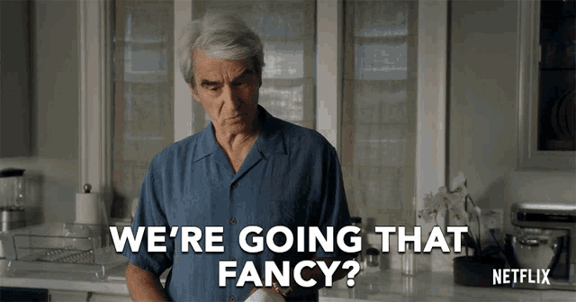 a man in a blue shirt says " we 're going that fancy " in a kitchen