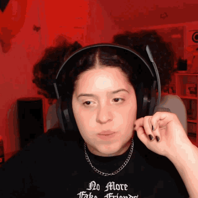 a girl wearing headphones has a shirt that says no more fake friends