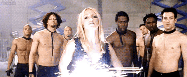 a group of men are standing around a woman with a light coming out of her chest ..