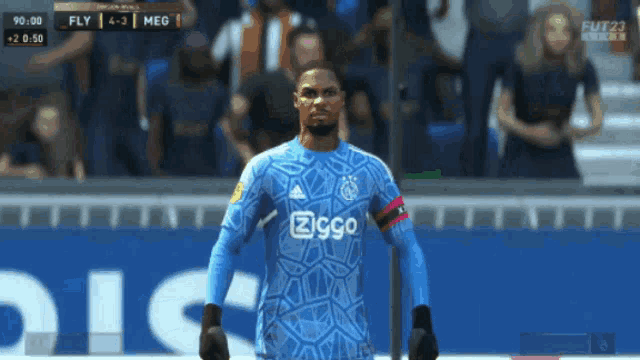 a soccer player wearing a blue jersey with ziggo on the front