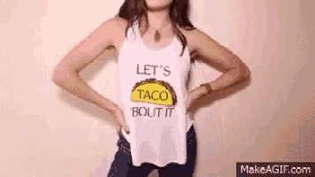 a woman is wearing a white tank top with a taco on it .