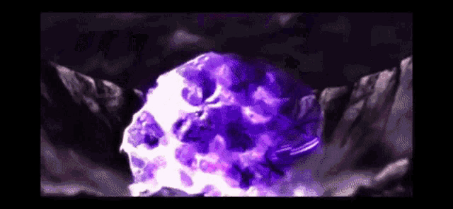 a purple and white explosion is taking place in the middle of a dark cave .