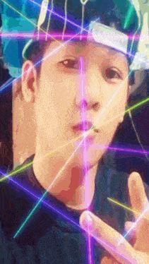 a young man wearing a blue hat and sunglasses is surrounded by neon lights