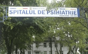 a large white banner is hanging from a pole in front of a building .