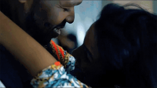 a man and a woman are kissing and the woman is wearing a bracelet