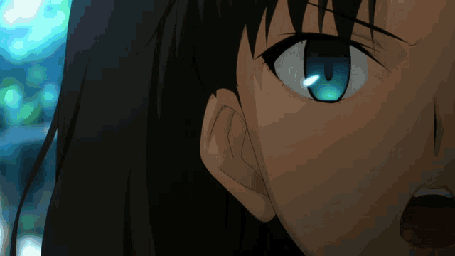 a close up of a woman 's face with a blue eye