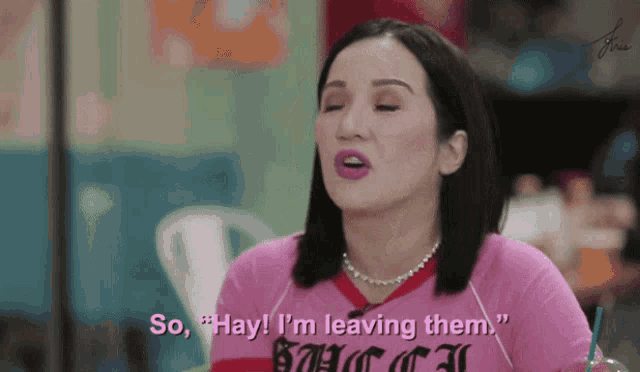 a woman wearing a pink shirt that says " so hay i 'm leaving them "