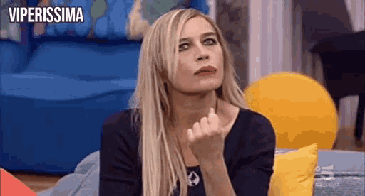 a woman is sitting on a couch and making a funny face with the words viperissima in the background