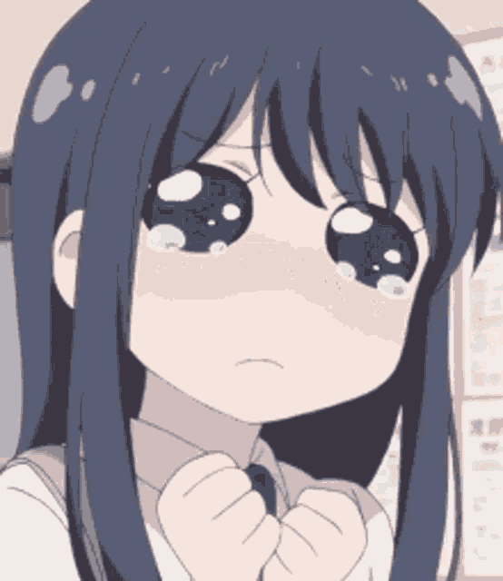 a close up of a girl 's face with tears coming out of her eyes