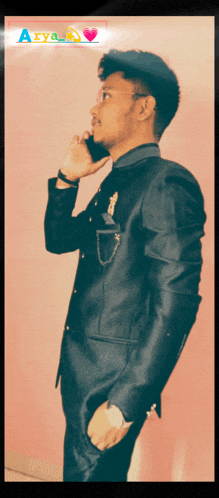 a man in a suit talking on a cell phone with the word aey on the bottom left