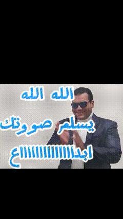a man wearing sunglasses and a suit stands in front of a sign that says " allah "