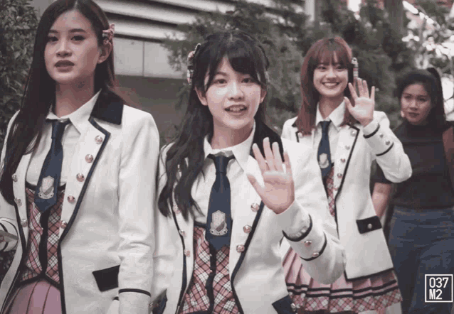 a group of girls are standing in a line with the number 037 on the bottom