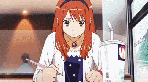 a girl with red hair is writing on a piece of paper in front of a cup that says mcdonald 's