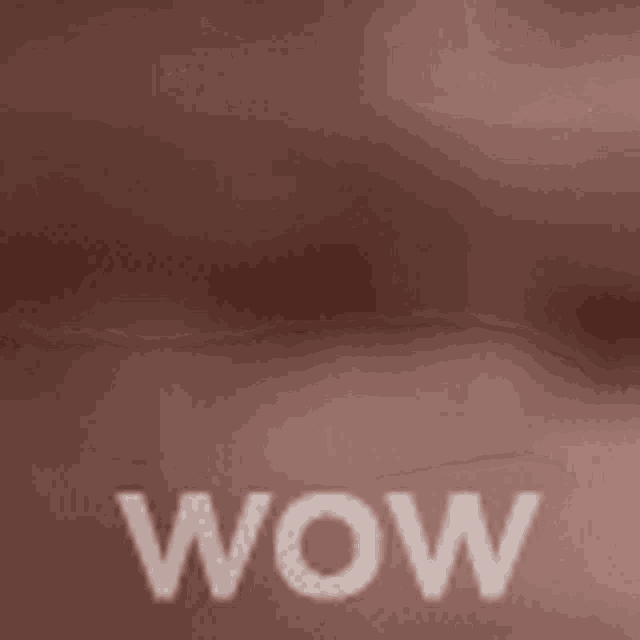 the word wow is written on a brown background .