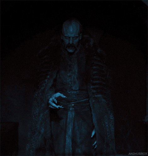 a man in a fur coat is standing in the dark with the name animusrox on the bottom left