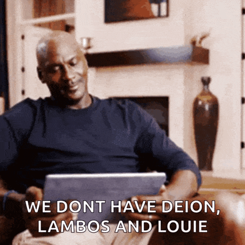 a man sitting on a couch looking at a tablet with the words " we dont have deion lambos and louie "
