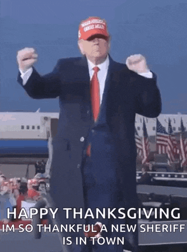 a man in a suit and tie is dancing in front of an airplane and flags .