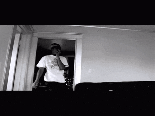 a black and white photo of a man wearing a t-shirt that says " i 'm a fool "