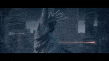 a person is standing in a dark room with a red light coming out of their hand .
