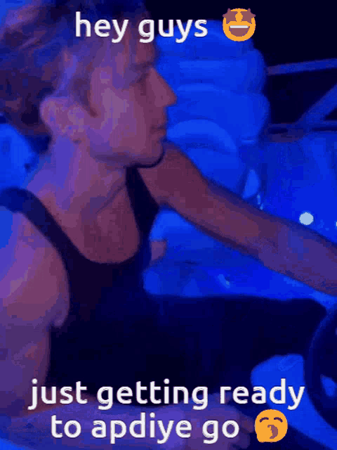 a man in a black tank top is driving a car with the words hey guys just getting ready to apdiye go