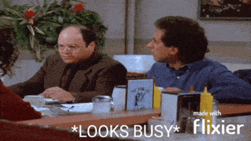 two men sitting at a table with a sign that says mom 's on it