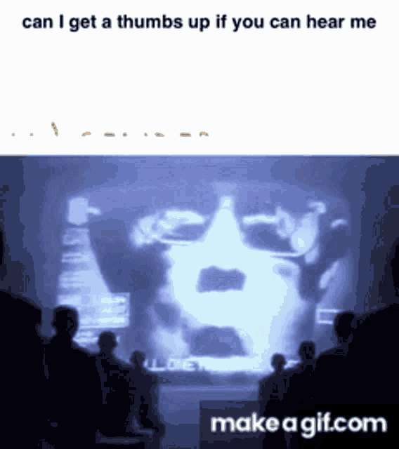 a group of people looking at a screen that says make a gif.com