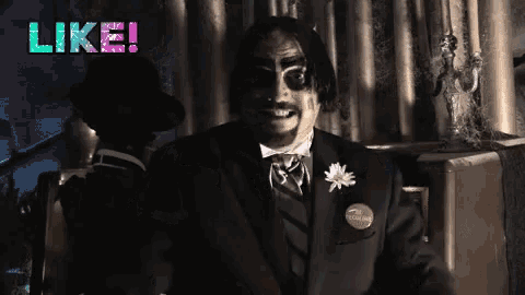 a man in a suit and tie is smiling with the words like behind him
