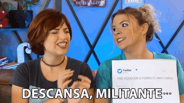 two women are holding a sign that says descansa militante