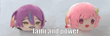 two stuffed anime characters are sitting next to each other with the words fami and power written on the bottom .