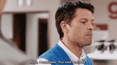 a man in a blue vest is talking to another man and says yeah i remember you said i sucked .