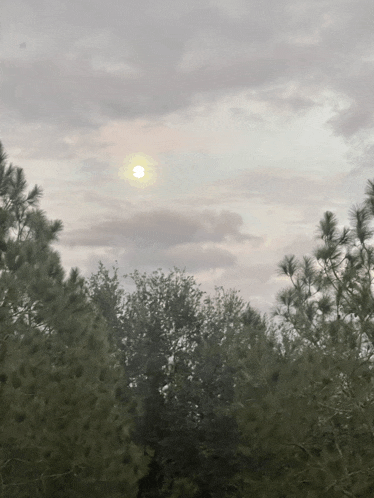 the sun is shining through the clouds in the sky