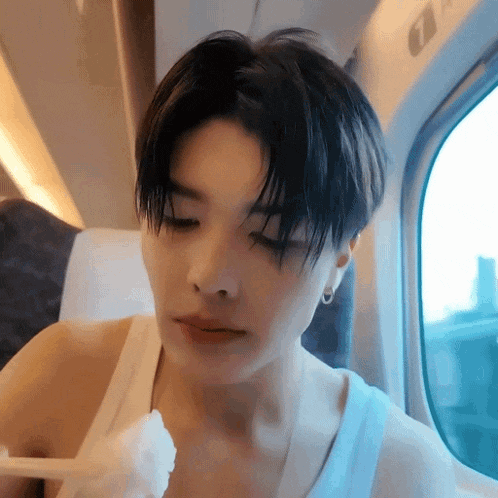 a close up of a person eating food on a train .