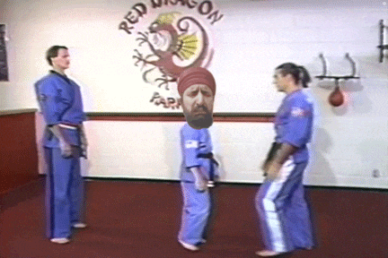 a man with a beard is standing in front of a wall that says red dragon park