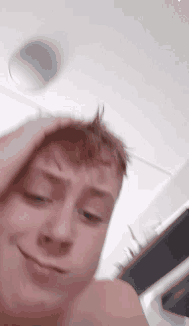 a young man without a shirt is making a funny face
