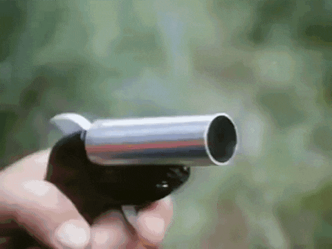 a close up of a person holding a gun