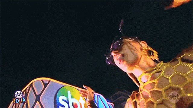a man in a bee costume is standing in front of a sign that says sbt