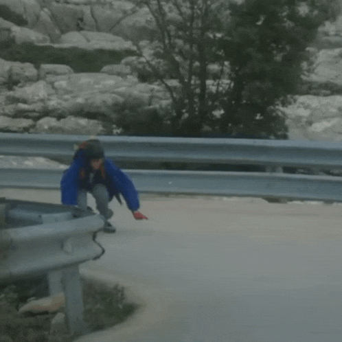 a person is riding a skateboard on a road